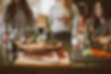 Three women chatting and drinking at the dinner table